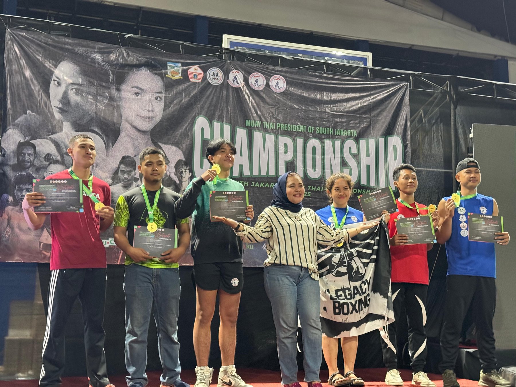 Legacy Boxing members on the championship podium with medals